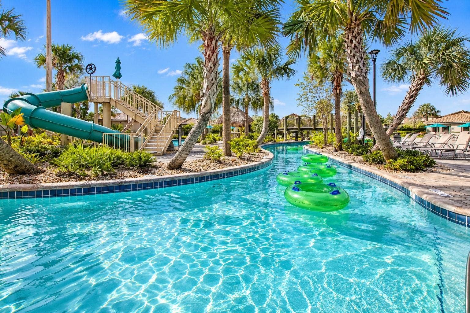 1516 BUNKER DRIVE, Davenport, FL 33896 Resort-style lazy river surrounded by tropical landscaping, lounge areas and water attractions.
