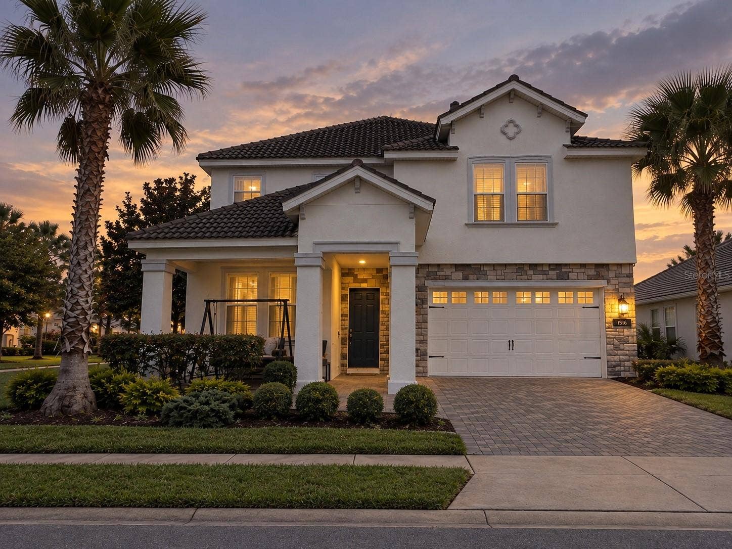 1516 BUNKER DRIVE, Davenport, FL 33896 Twilight view highlighting the home's welcoming exterior and architectural details.