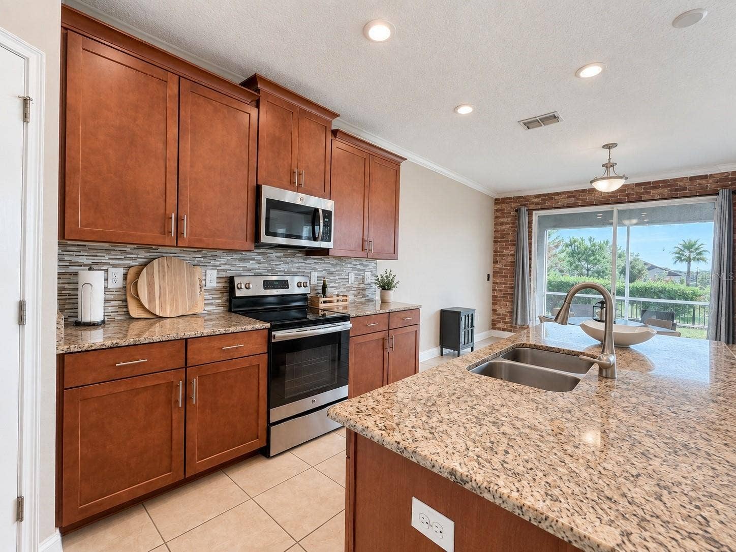 1516 BUNKER DRIVE, Davenport, FL 33896 Spacious kitchen with abundant cabinetry, generous counter space and an open connection to the main living area.
