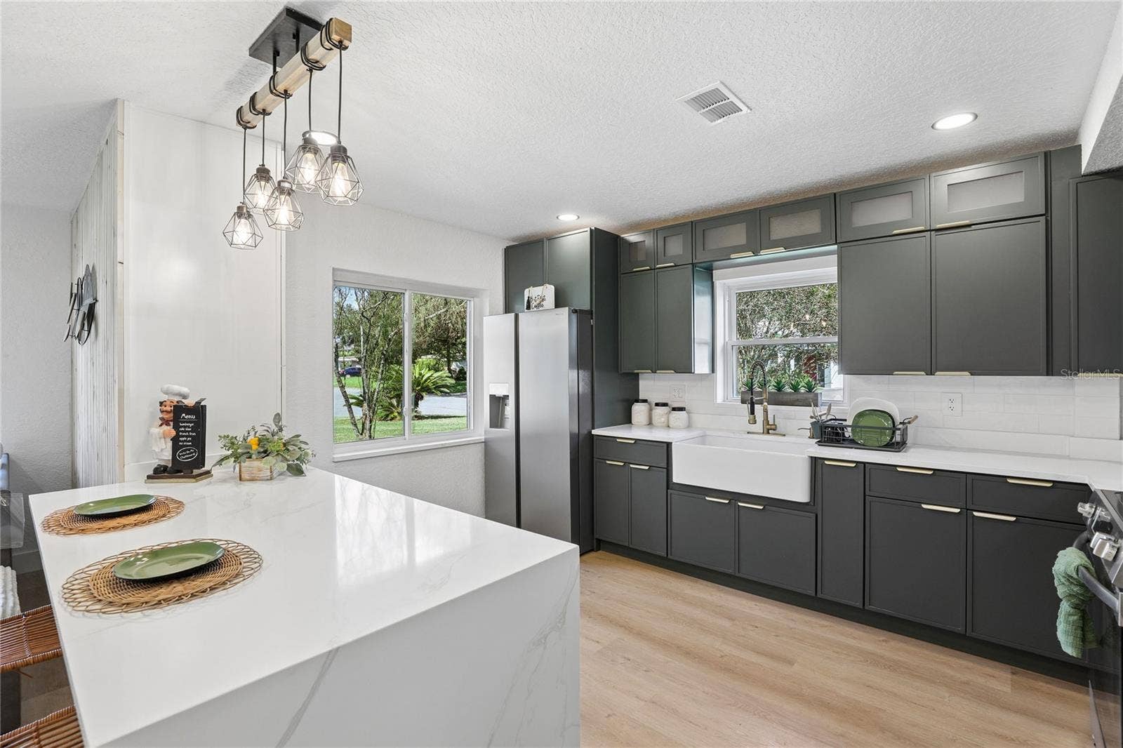 1718 CAMPBELL AVENUE, Orlando, FL 32806 Waterfall-edge island with seating, storage and statement pendant lighting
