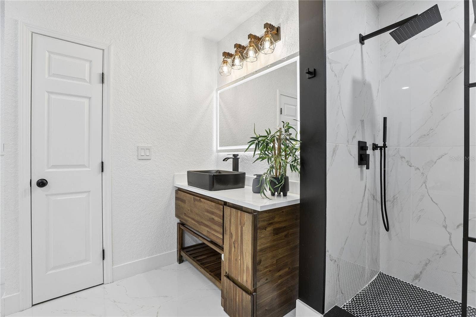 1718 CAMPBELL AVENUE, Orlando, FL 32806 Designer primary bath with vessel sink, illuminated mirror and modern finishes