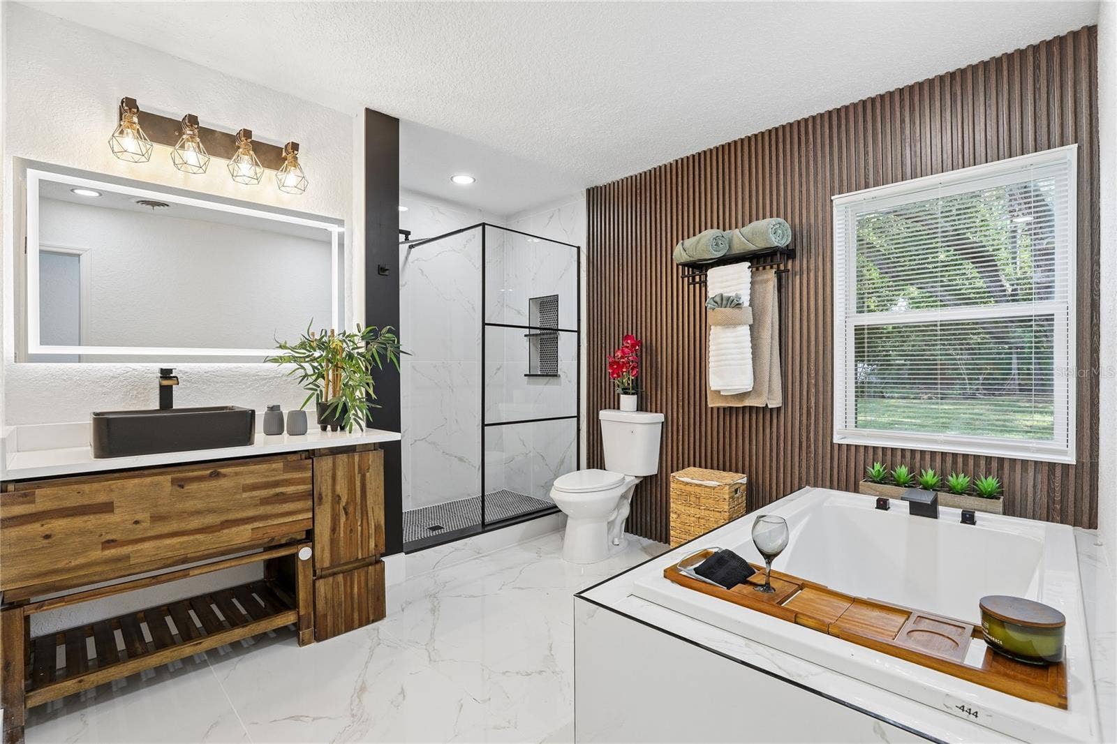 1718 CAMPBELL AVENUE, Orlando, FL 32806 Spa-inspired primary bath with soaking tub and custom wood accent wall