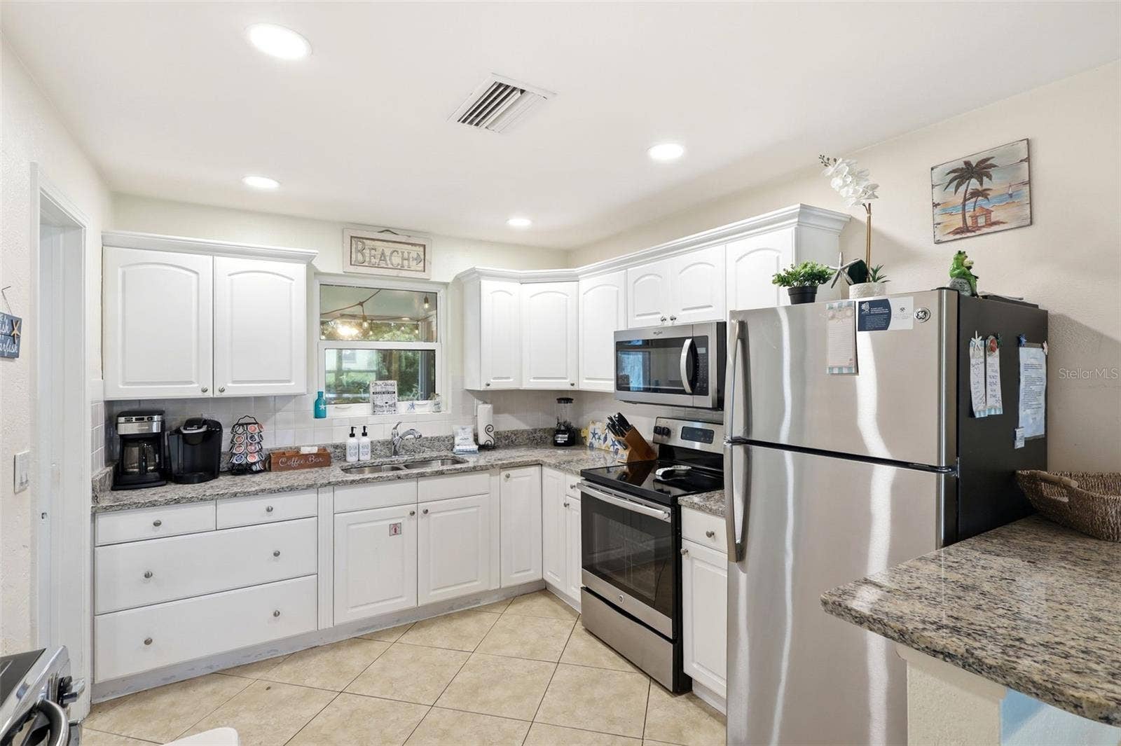 159 LAURIE DRIVE, Ormond Beach, FL 32176 Kitchen. White cabinets, granite, and stainless appliances