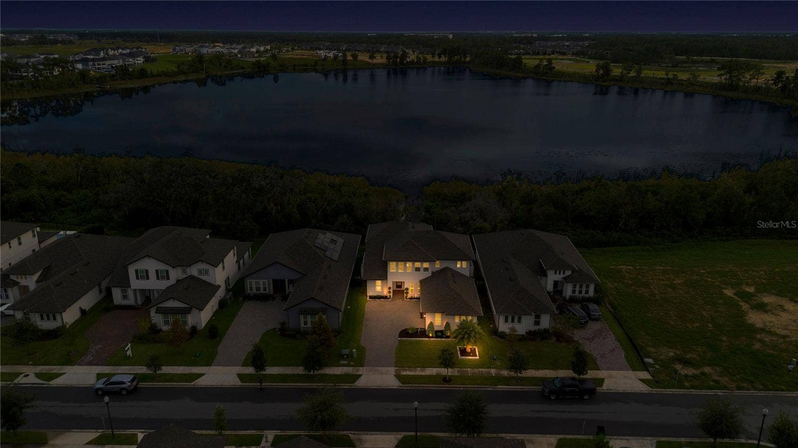 17600 LAKE STAR ROAD, Winter Garden, FL 34787 Wide twilight aerial captures the property, neighboring homes and lake setting.