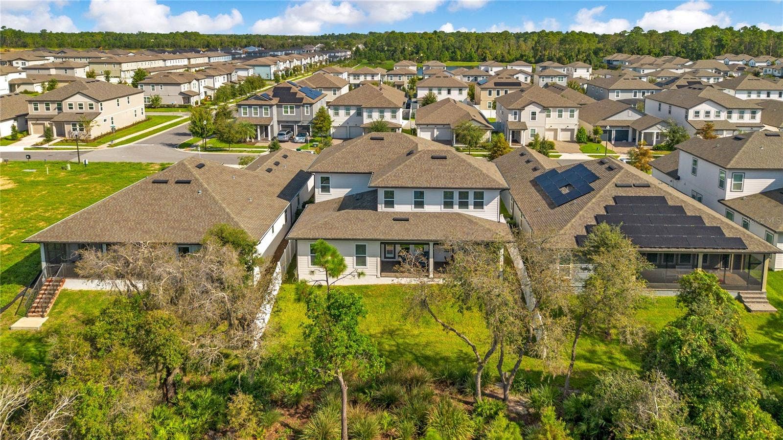 17600 LAKE STAR ROAD, Winter Garden, FL 34787 Rear aerial view highlights the spacious backyard, covered lanai and mature trees.