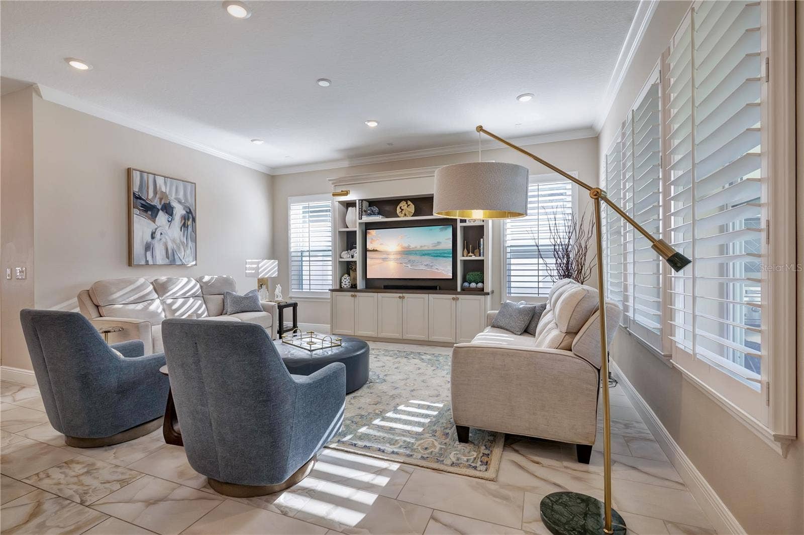 17600 LAKE STAR ROAD, Winter Garden, FL 34787 Inviting family room featuring crown molding, recessed lighting and plantation shutters.