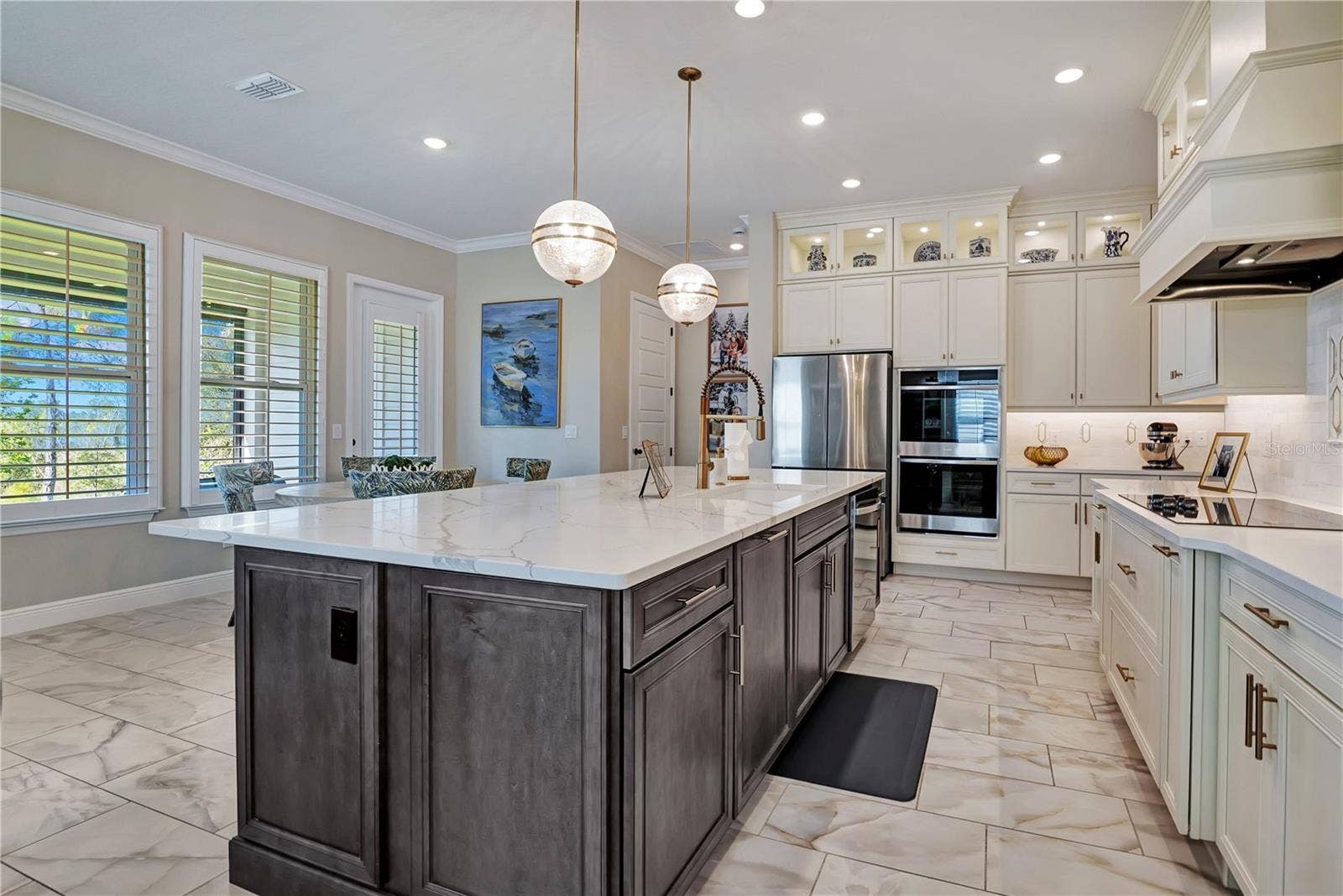 17600 LAKE STAR ROAD, Winter Garden, FL 34787 Designer kitchen with stacked cabinetry, illuminated upper display cabinets and built-in stainless steel appliances.