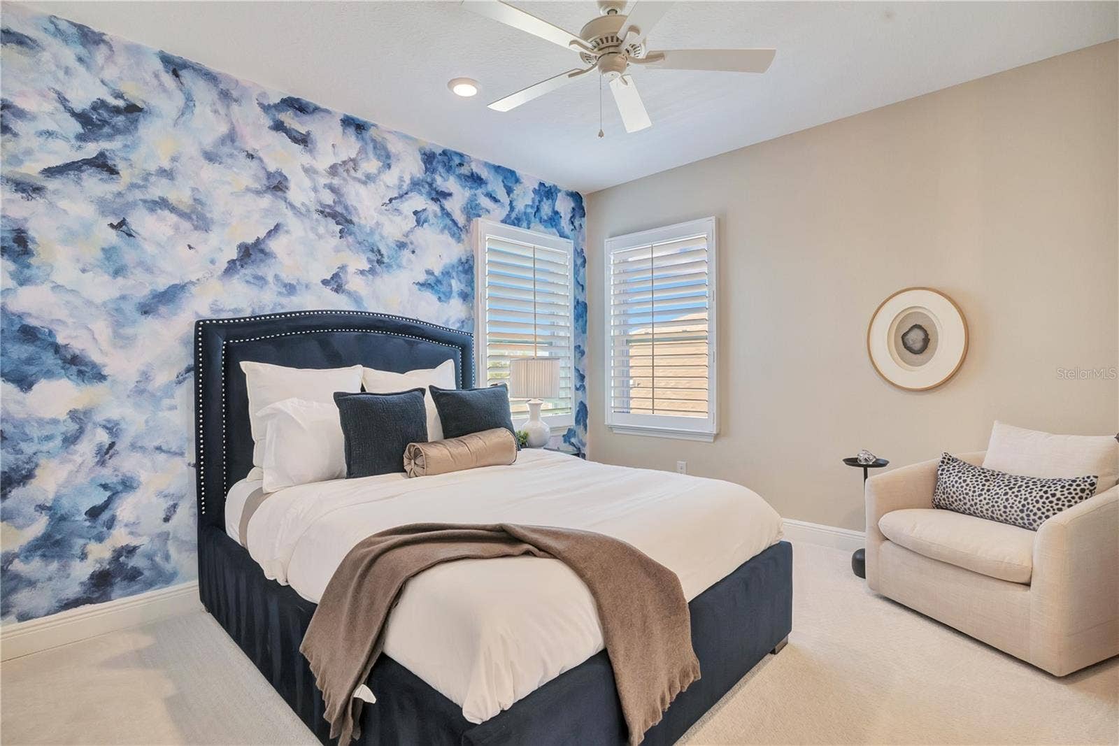 17600 LAKE STAR ROAD, Winter Garden, FL 34787 Bedroom featuring a blue statement accent wall, plush carpet and space for a reading chair.