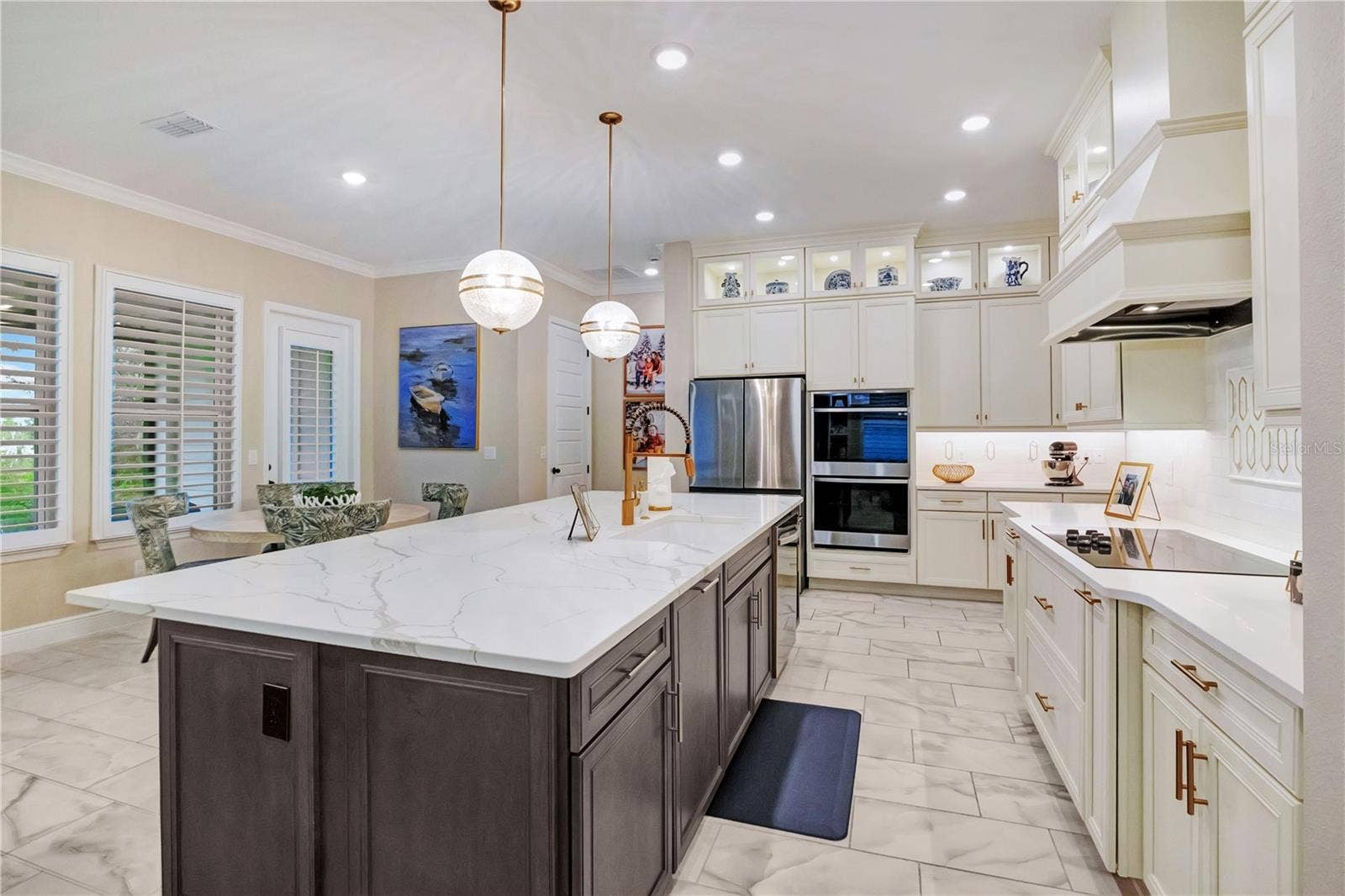 17600 LAKE STAR ROAD, Winter Garden, FL 34787 Beautifully appointed kitchen featuring a decorative backsplash, statement range hood and abundant cabinet storage.