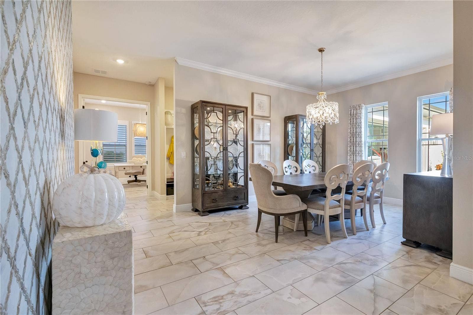 17600 LAKE STAR ROAD, Winter Garden, FL 34787 Elegant dining room featuring a statement chandelier, crown molding and upgraded tile flooring.
