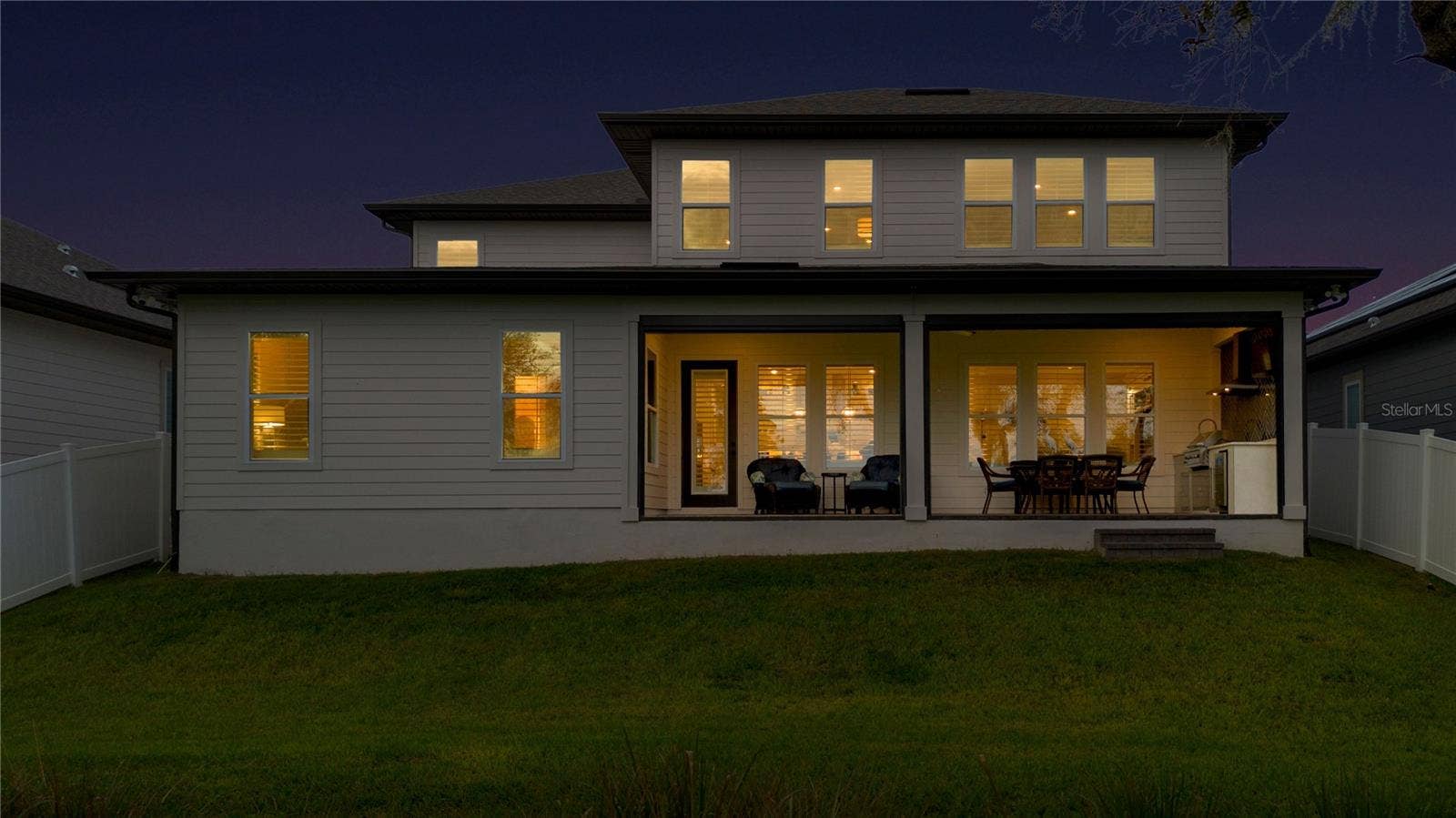 17600 LAKE STAR ROAD, Winter Garden, FL 34787 Rear twilight view featuring the covered lanai and inviting outdoor living areas.
