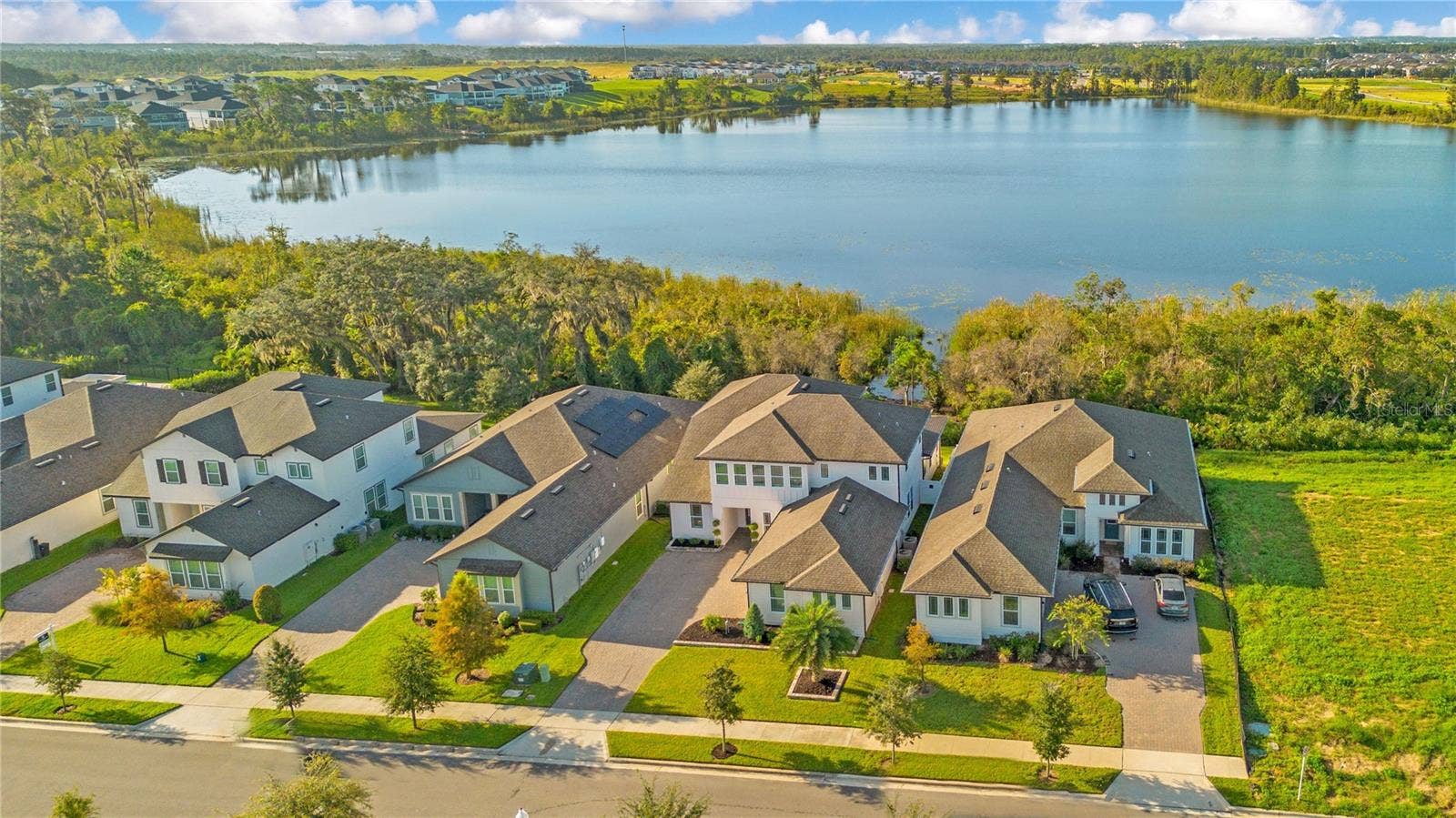 17600 LAKE STAR ROAD, Winter Garden, FL 34787 Aerial view showcasing the homes scenic setting with the lake behind it.