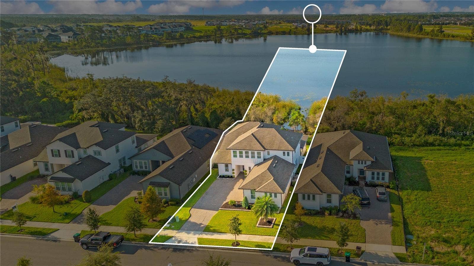 17600 LAKE STAR ROAD, Winter Garden, FL 34787 Aerial view highlights the homes setting beside the lake. Outline is approximate and for illustration only.