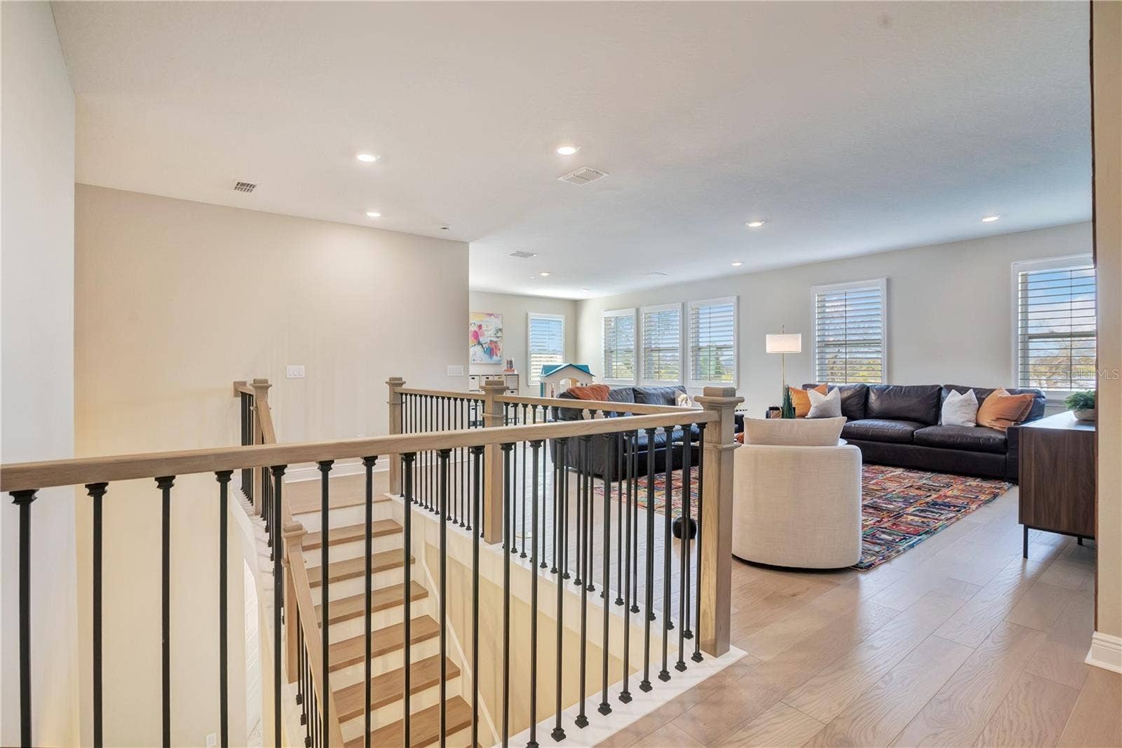 17600 LAKE STAR ROAD, Winter Garden, FL 34787 Open upstairs landing with upgraded stair railings leads into a spacious loft.