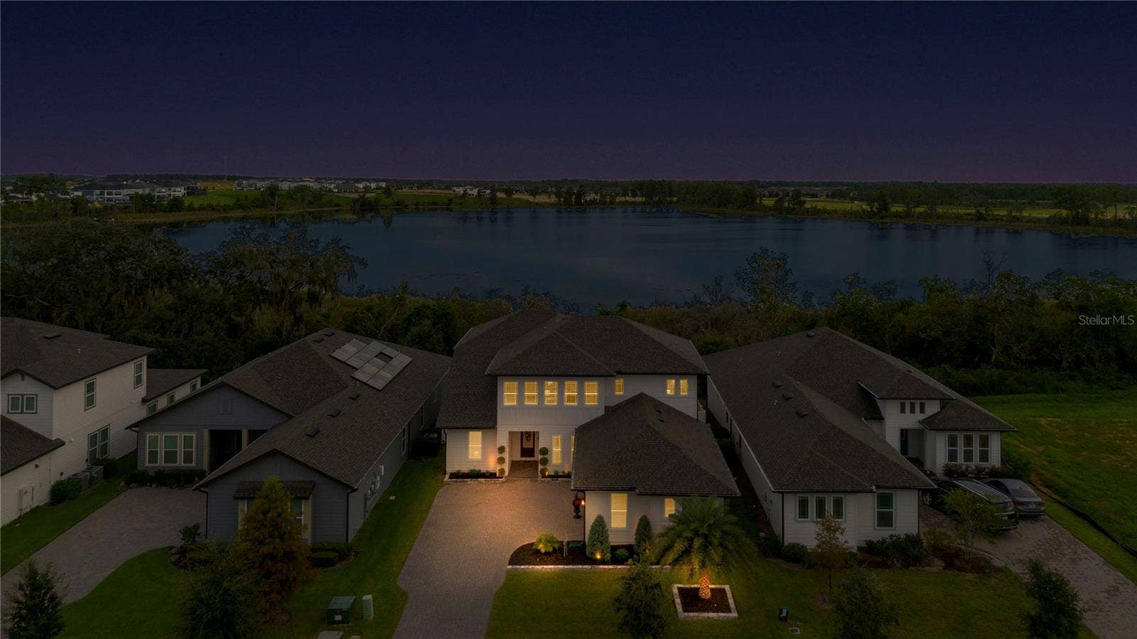 17600 LAKE STAR ROAD, Winter Garden, FL 34787 Elevated twilight view featuring the home and lake backdrop.