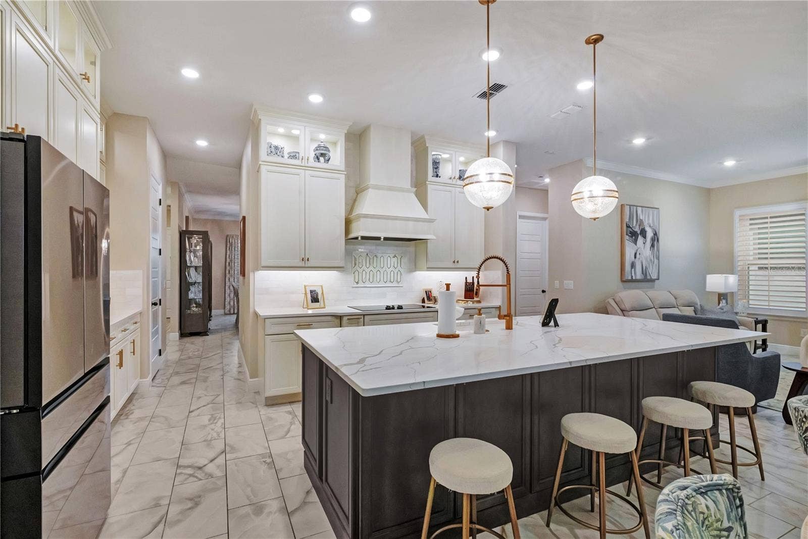 17600 LAKE STAR ROAD, Winter Garden, FL 34787 Upgraded kitchen featuring an oversized island with seating, contrasting cabinetry and designer pendant lighting.