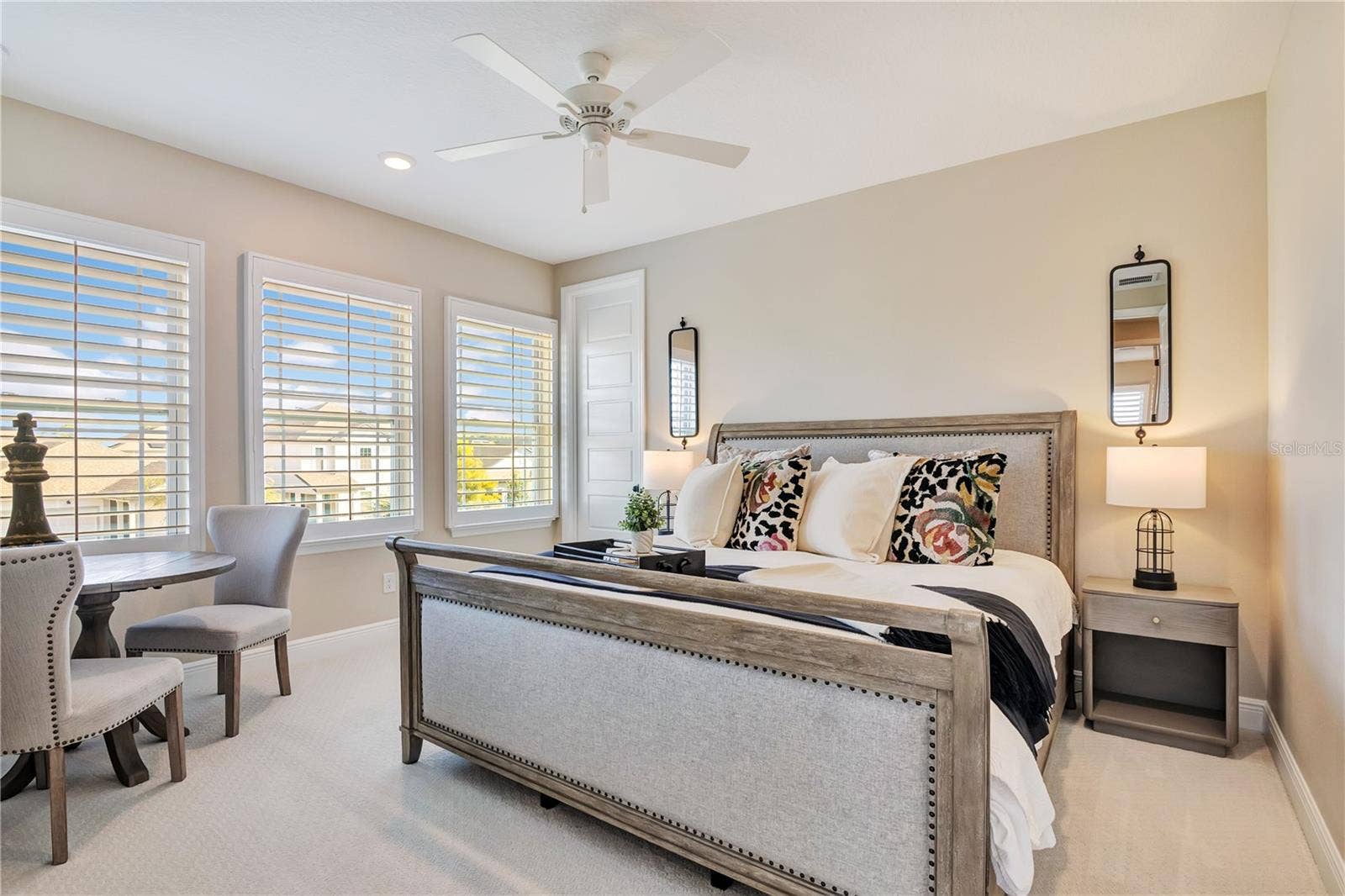 17600 LAKE STAR ROAD, Winter Garden, FL 34787 Inviting bedroom featuring plush carpet, plantation shutters and a ceiling fan.