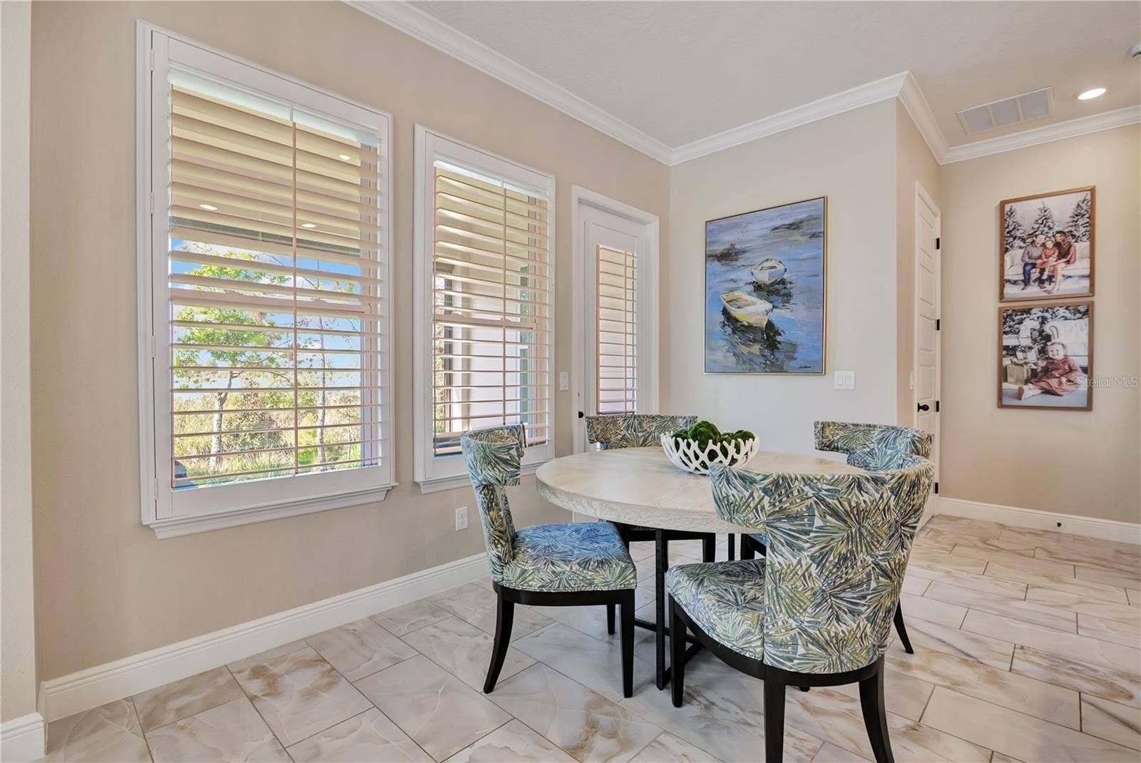 17600 LAKE STAR ROAD, Winter Garden, FL 34787 Sunlit breakfast nook surrounded by windows with plantation shutters, conveniently located beside the kitchen.