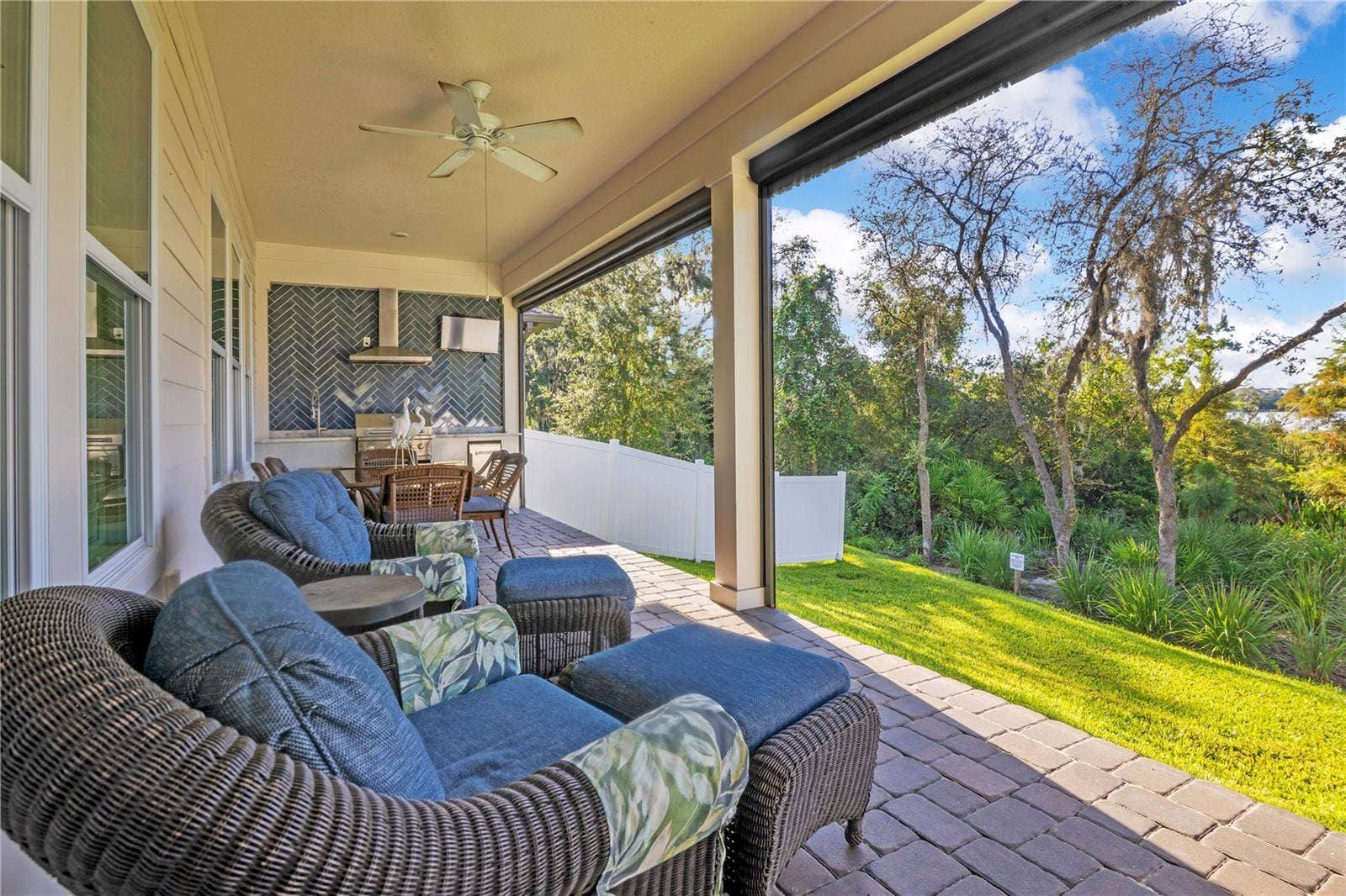 17600 LAKE STAR ROAD, Winter Garden, FL 34787 Covered paver lanai offers a relaxing outdoor lounge overlooking the backyard and mature trees.