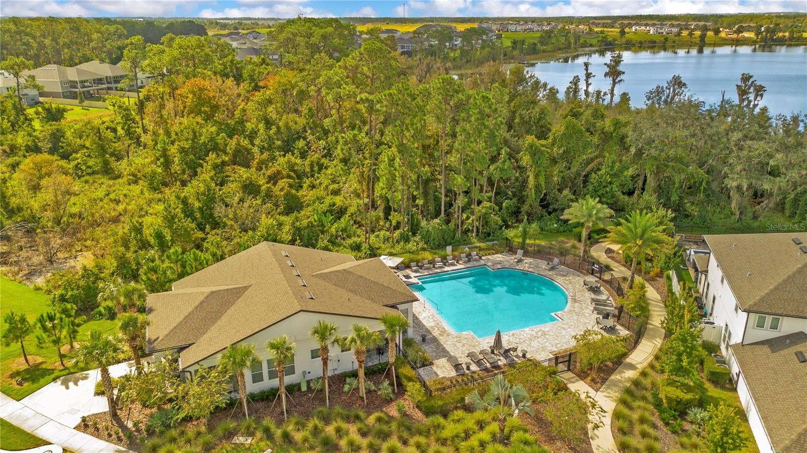 17600 LAKE STAR ROAD, Winter Garden, FL 34787 Community pool and clubhouse surrounded by landscaped grounds and mature trees.