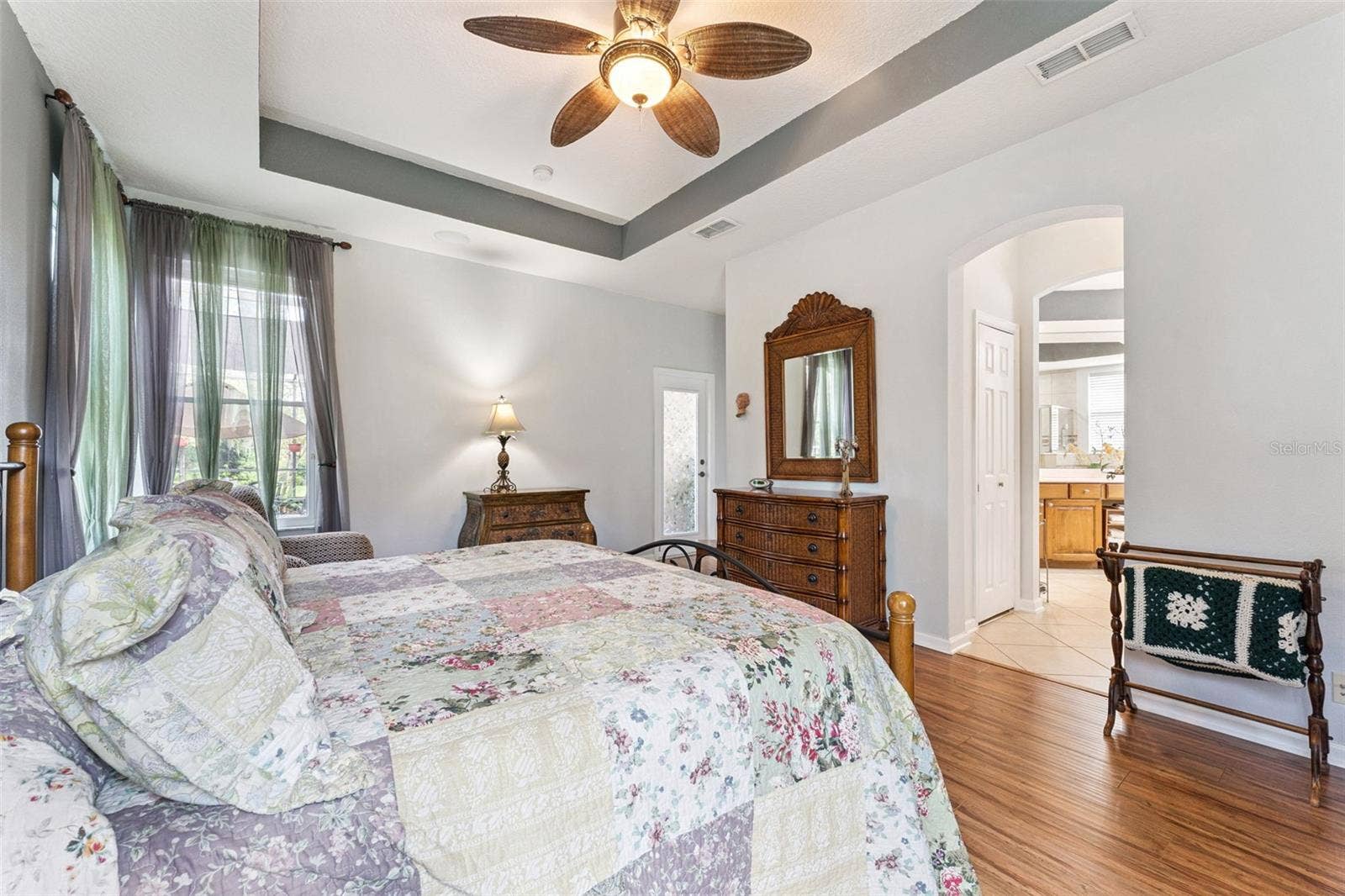 108 AVENHAM DRIVE, Deland, FL 32724 Primary Bedroom w/ a French door that leads to the screen enclosed covered patio