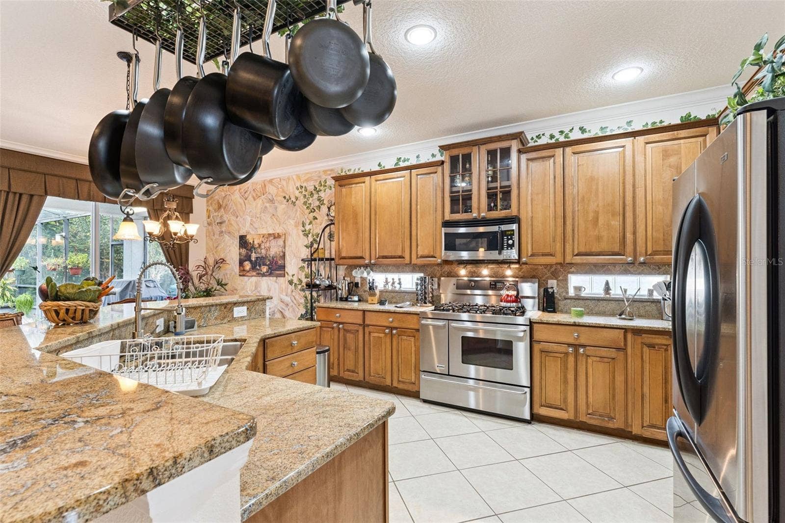 108 AVENHAM DRIVE, Deland, FL 32724 13' x 13'6" Kitchen w/ granite countertops, 5-burner natural gas convection range & exterior wall glass block inserts
