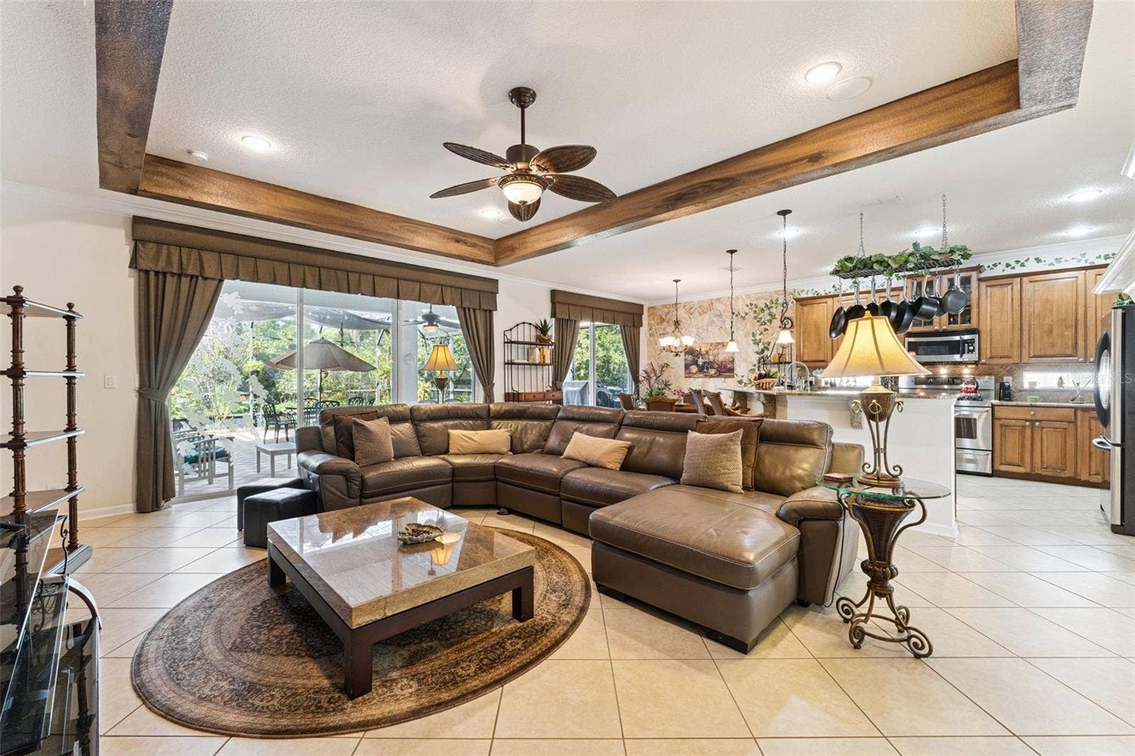108 AVENHAM DRIVE, Deland, FL 32724 View of the 30' x 32' screen enclosed covered patio w/ brick pavers & conservation area from the Family Room