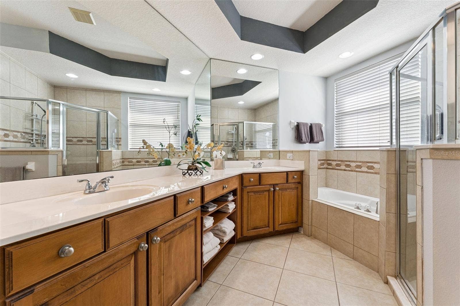 108 AVENHAM DRIVE, Deland, FL 32724 11'6" x 11' Primary Bathroom w/ a raised height vanity, dual sinks, corner soaking tub & glass enclosed walk-in shower