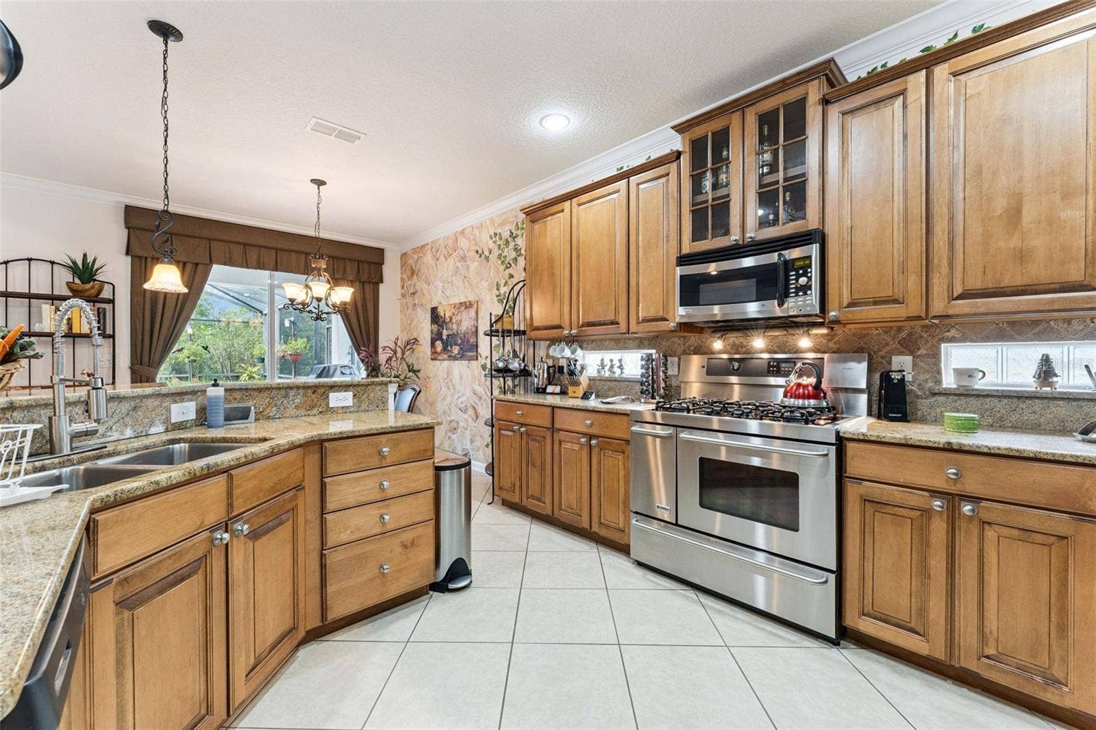 108 AVENHAM DRIVE, Deland, FL 32724 Kitchen w/ stainless steel appliances, tile backsplash & 42" Maple cabinets