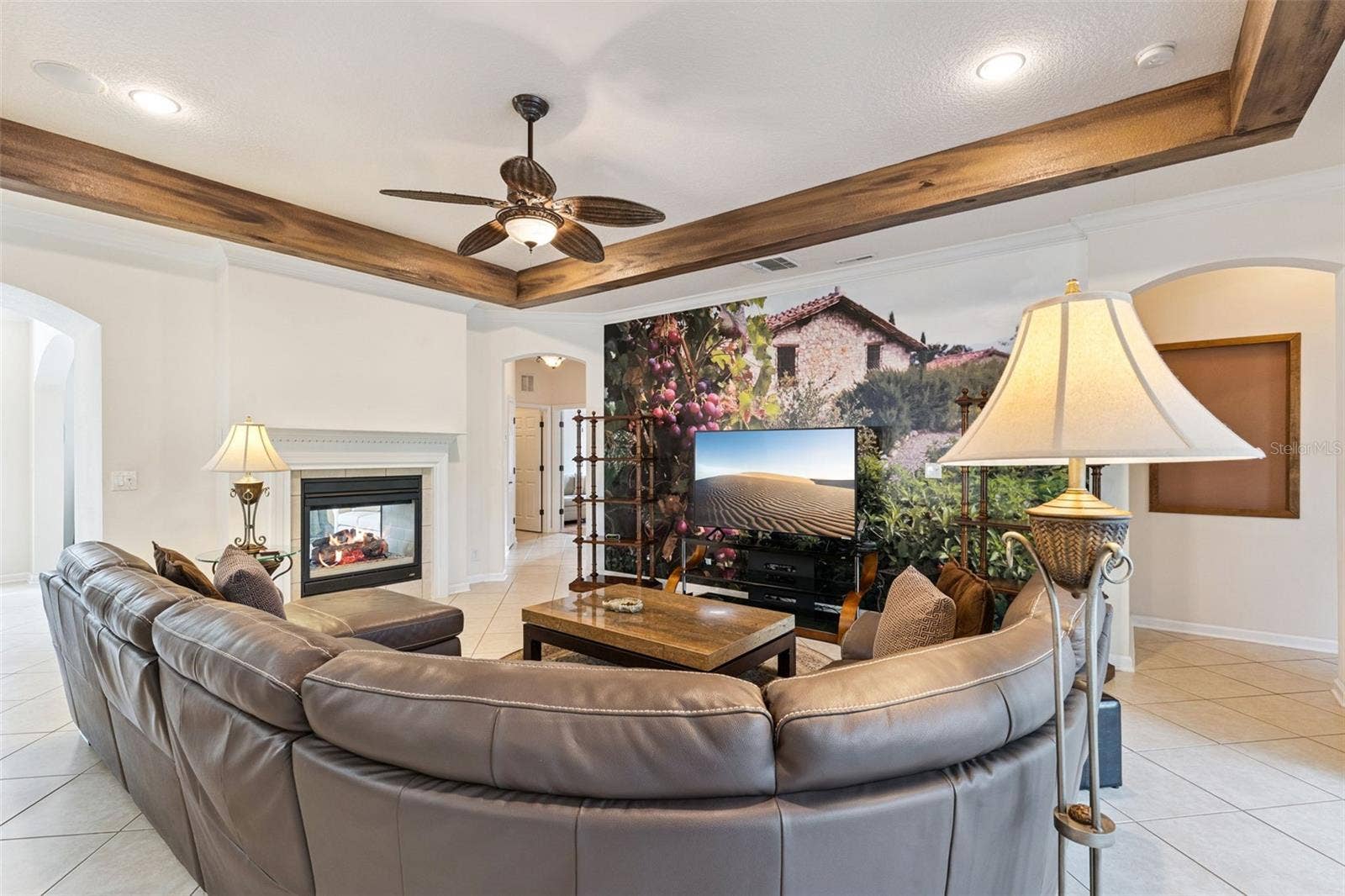 108 AVENHAM DRIVE, Deland, FL 32724 Family Room w/ a double sided natural gas fireplace, decorative accent wall & crown molding