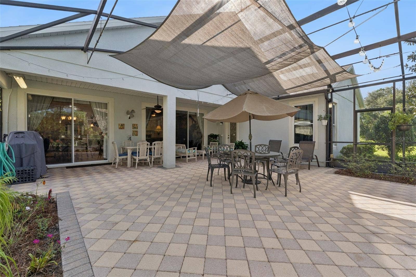 108 AVENHAM DRIVE, Deland, FL 32724 Screen enclosed covered patio w/ brick pavers, an awning & lighting