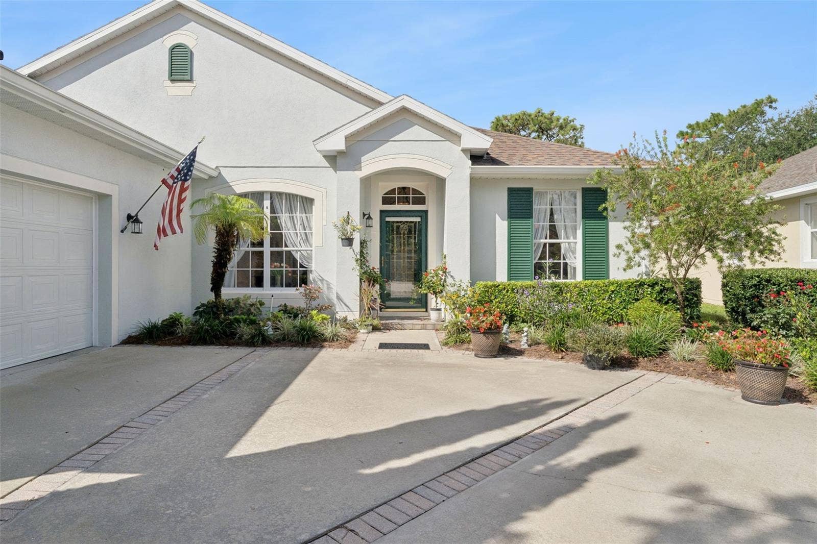 108 AVENHAM DRIVE, Deland, FL 32724 Exterior front of the home w/ a leaded glass front door & storm door