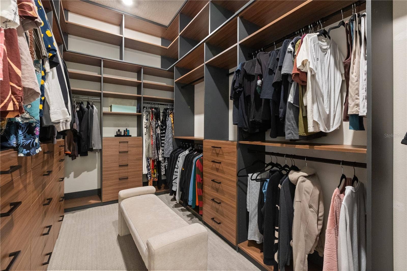 One set of two closets in master suite with custom cabinetry