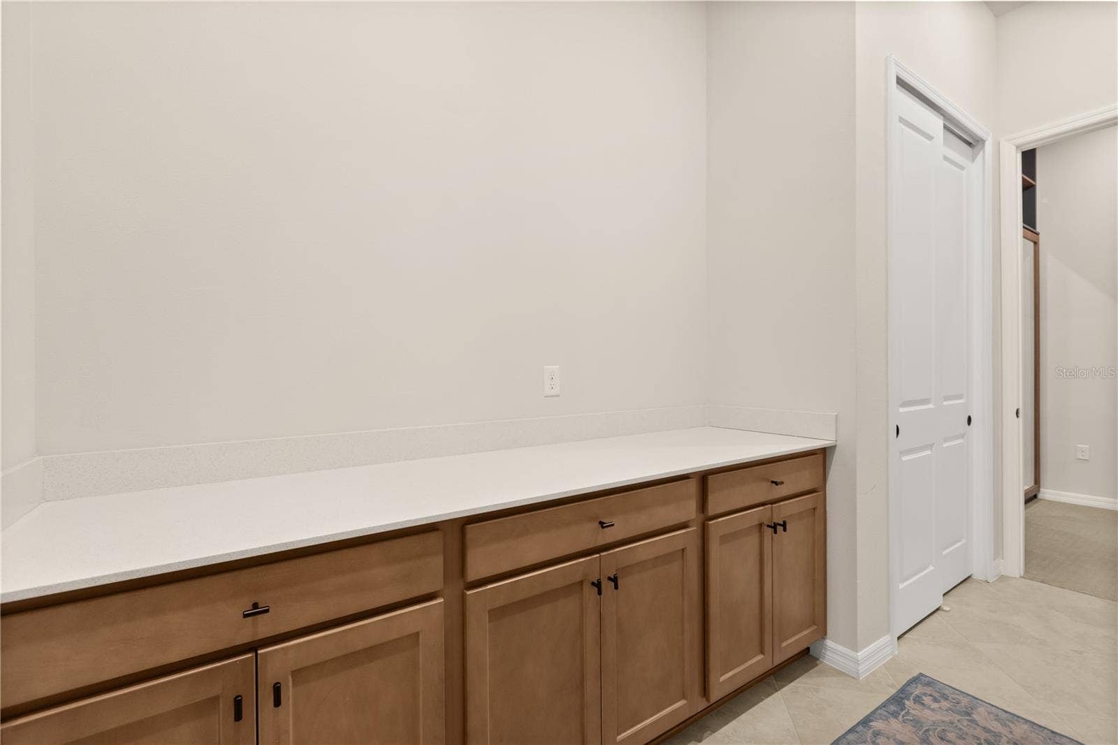Oversized, gorgeous laundry room with sink and tons of space for storage