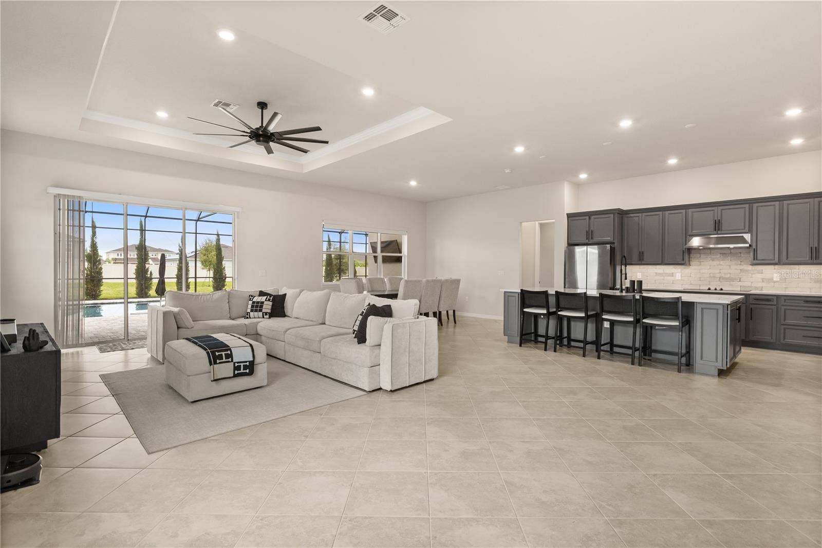 Oversized living area with dining room/ kitchen combo with pool views
