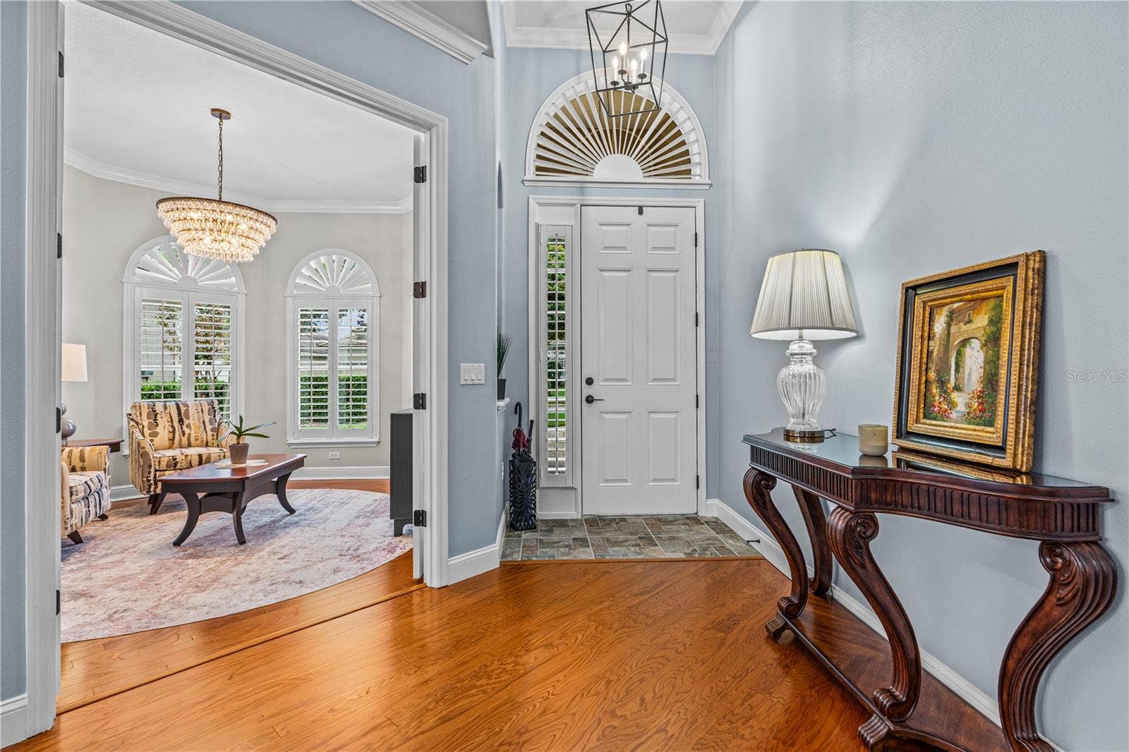 520 SOTHEBY WAY, Debary, FL 32713 In the foyer looking toward the front door with the pretty arched transom window and into the front den/office through the open French doors