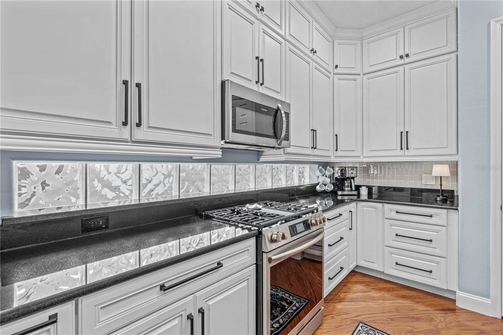 520 SOTHEBY WAY, Debary, FL 32713 Granite on the perimeter counters with the glass block windows providing even more natural light; And check out all those drawers!