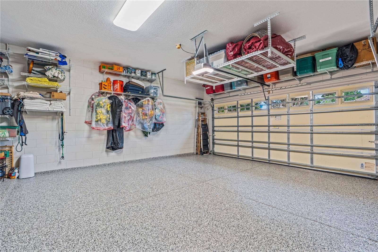520 SOTHEBY WAY, Debary, FL 32713 The shelving above the garage door and hanging in front of the garage door opener conveys; The shelving & hangers shown on the side wall does not convey