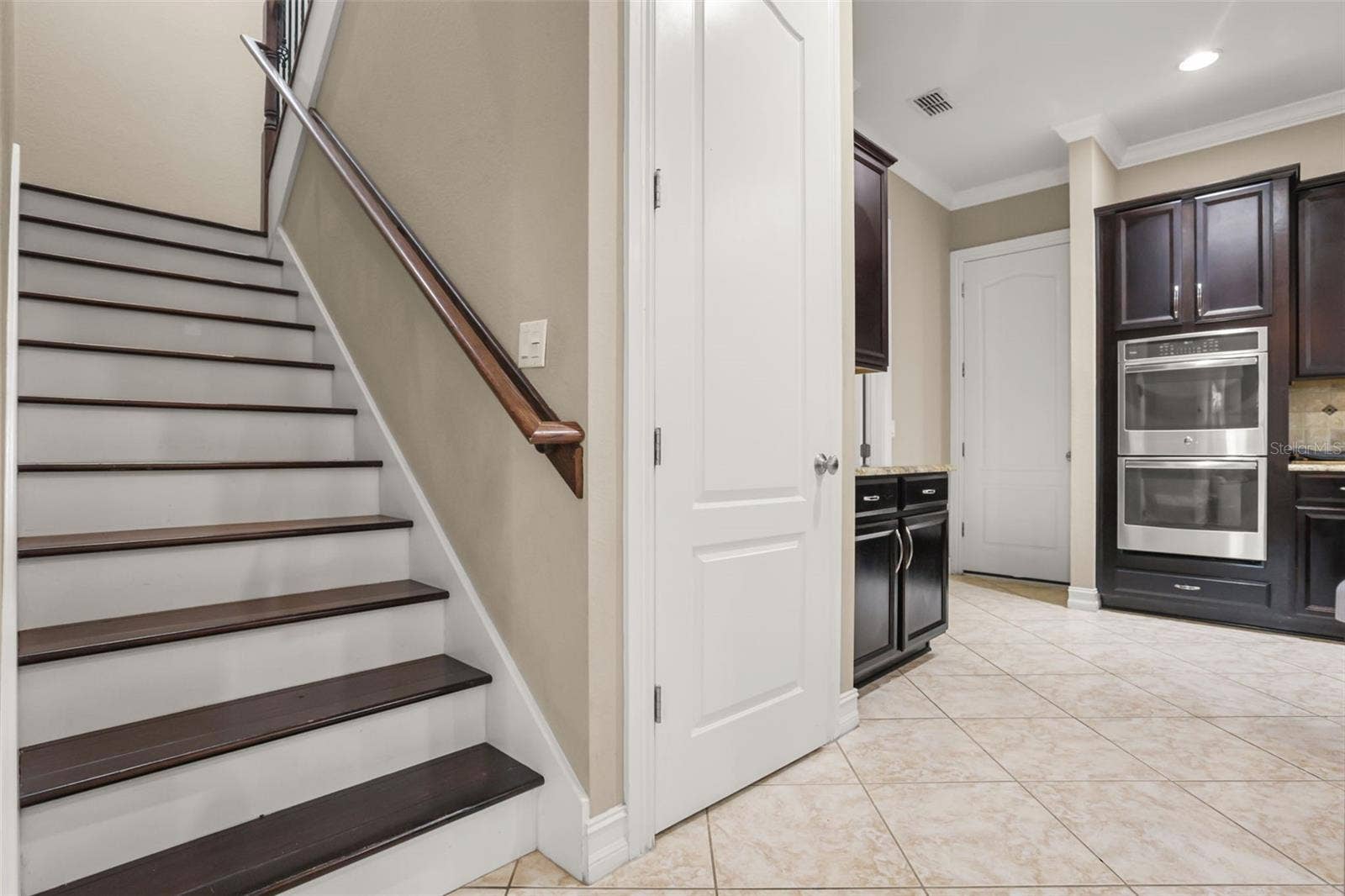 1260 BELLA VISTA CIRCLE, Longwood, FL 32779 Stairs to 4 bedrooms and 3 bathrooms. To the right of the stairs is the pantry, laundry room and door leading to the 3 car garage