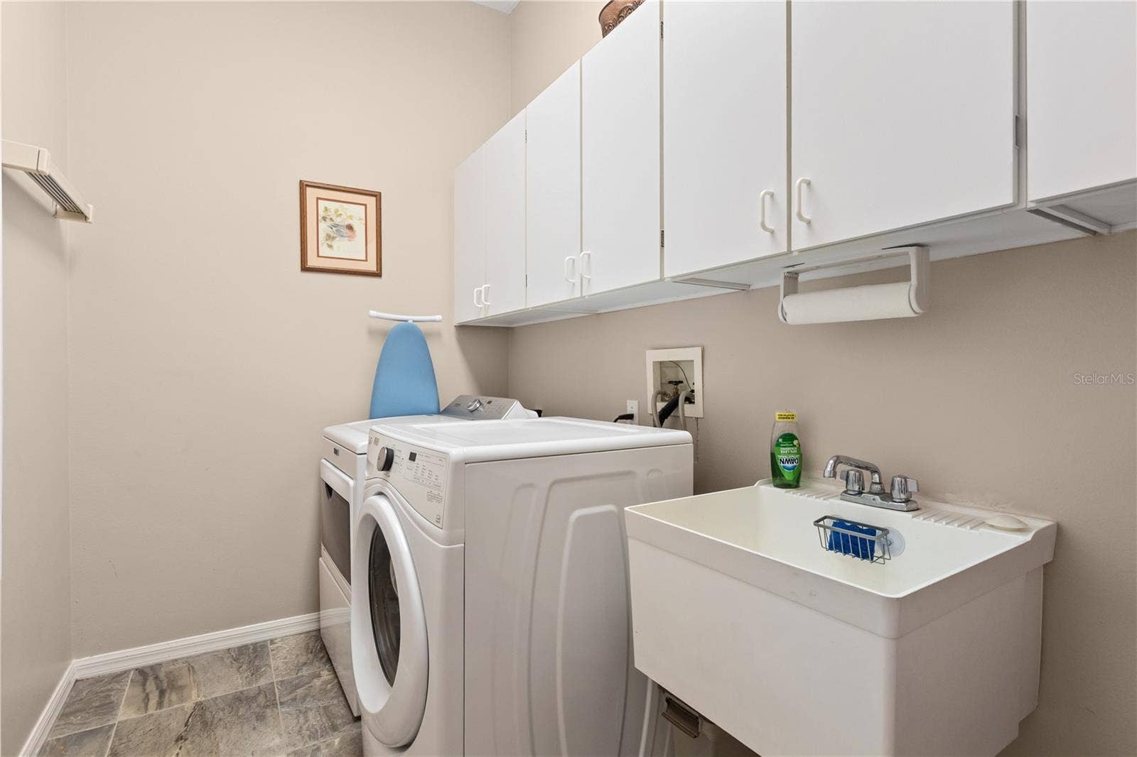 Spacious laundry room with plenty of room for storage and a sink