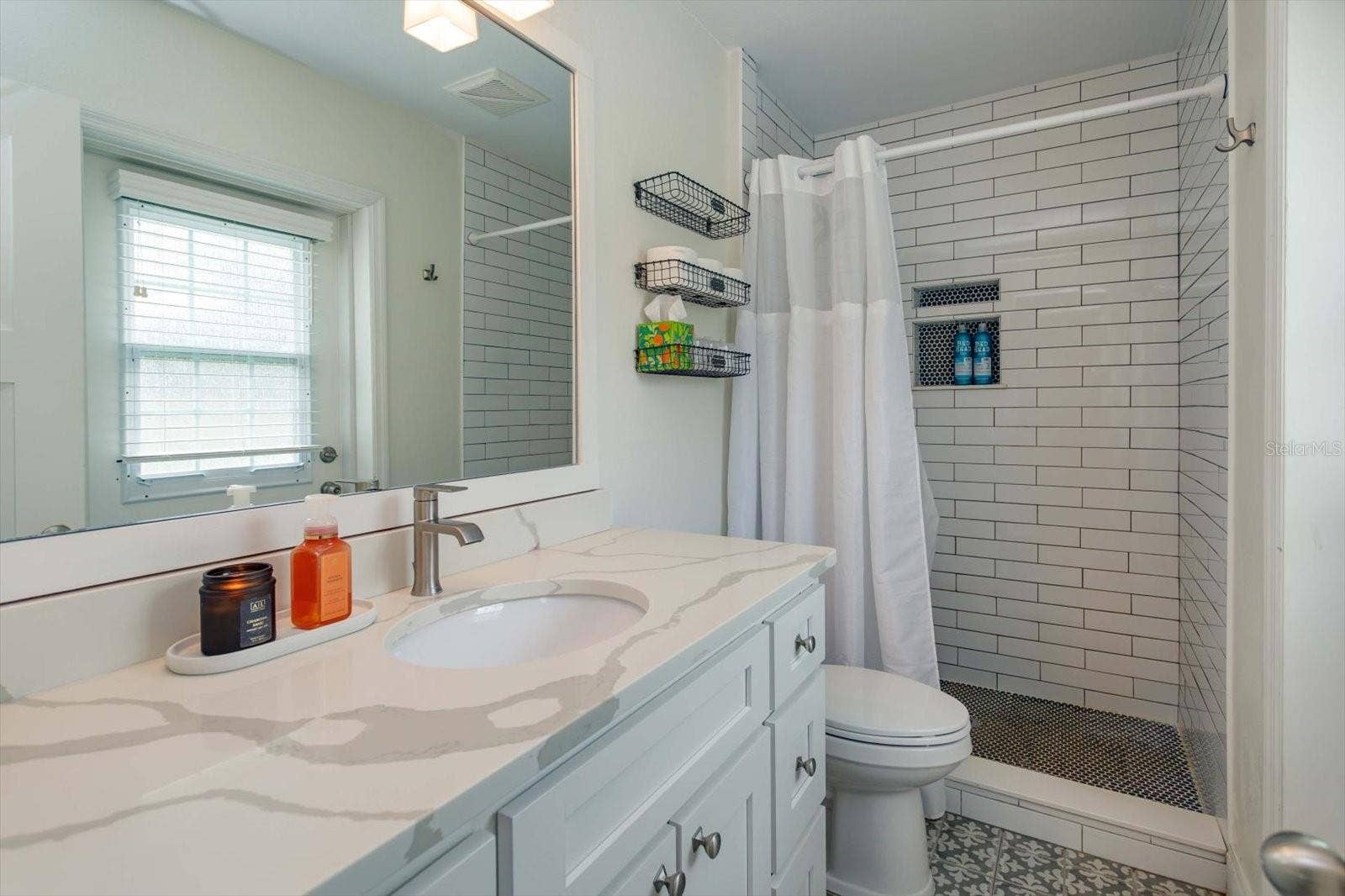 2322 WOODCREST DRIVE, Winter Park, FL 32792 Renovated primary shower with shaker vanity, stone counter, new lighting and fixtures