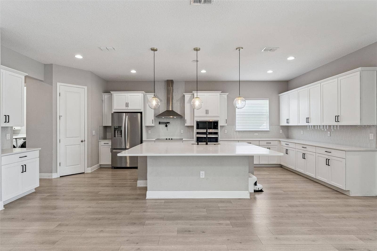 19058 PLANETREE STREET, Orlando, FL 32827 Bright kitchen featuring a large island and open-concept layout.