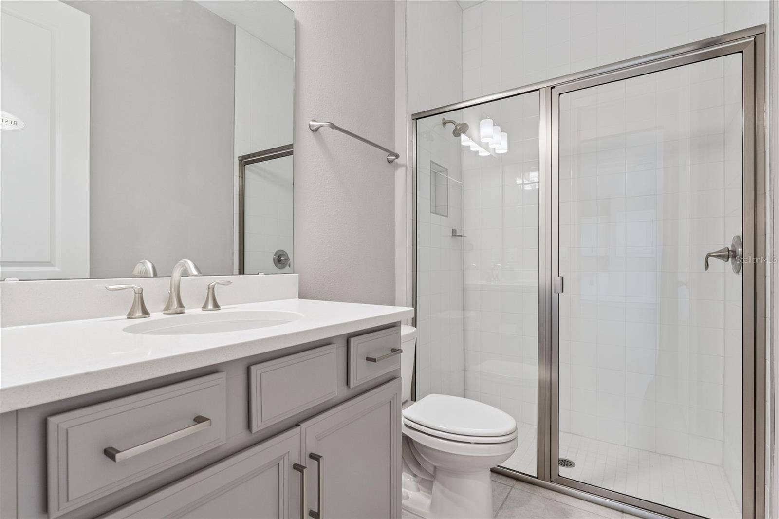 19058 PLANETREE STREET, Orlando, FL 32827 Full bathroom with modern vanity and tub/shower combination.