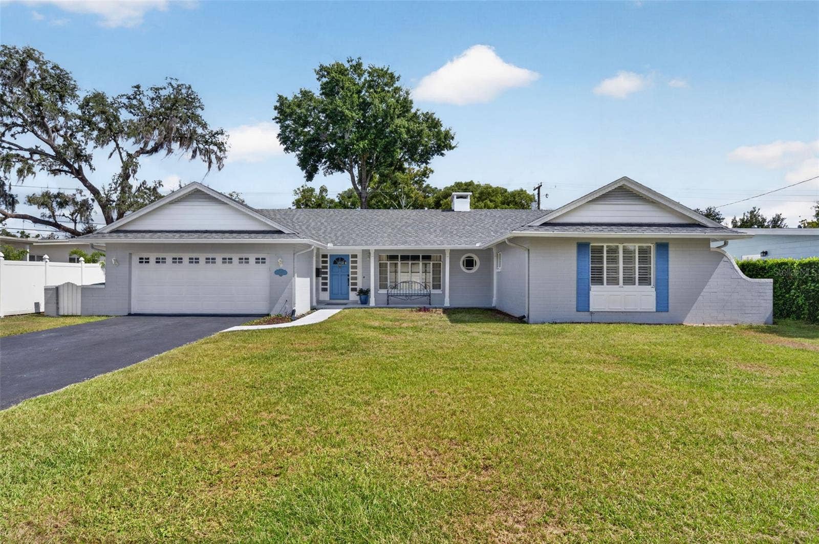 200 SENECA TRAIL, Maitland, FL 32751 Front Exterior Block-constructed, single-story home with an attached two-car garage, large-format windows and a welcoming covered front porch.