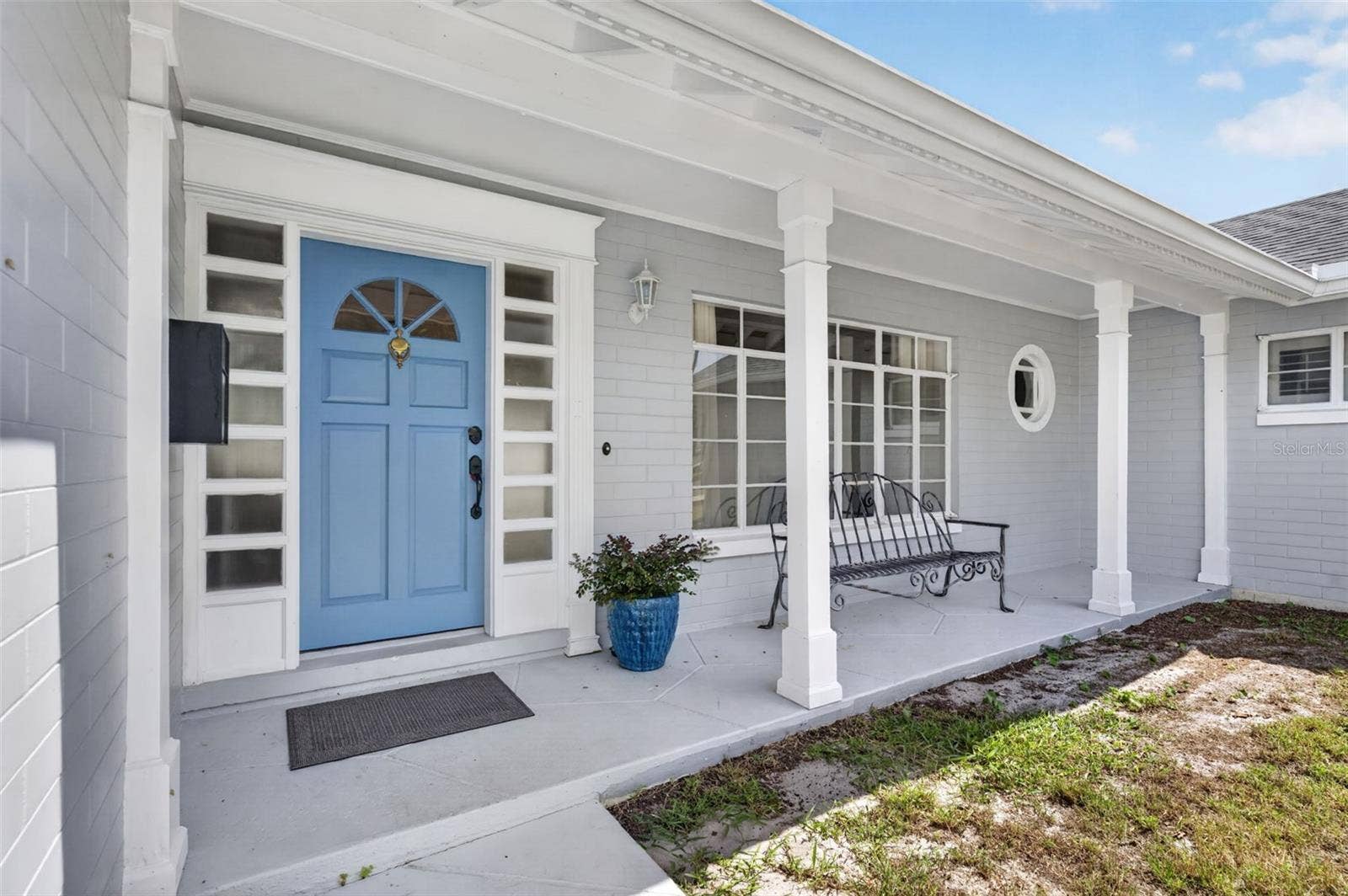 200 SENECA TRAIL, Maitland, FL 32751 Covered Front Porch Welcoming covered porch with a distinctive blue front door framed by detailed millwork and sidelights.