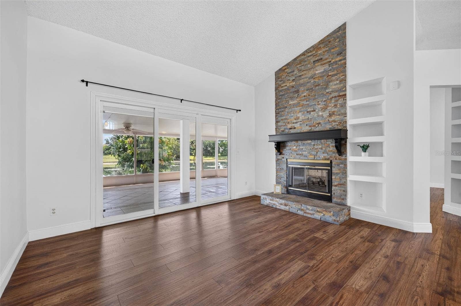 The custom stone work on the wood burning fireplace adds style and warmth to the room.