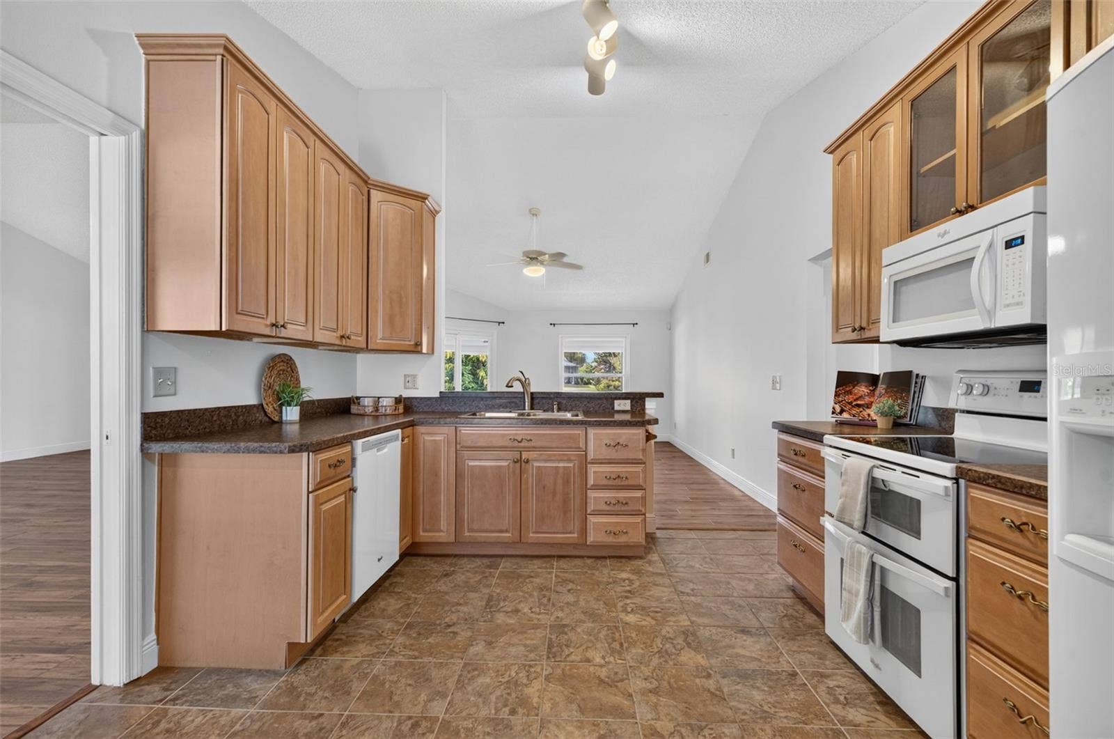 Kitchen features include 42" cabinets, a double oven, and a breakfast bar.