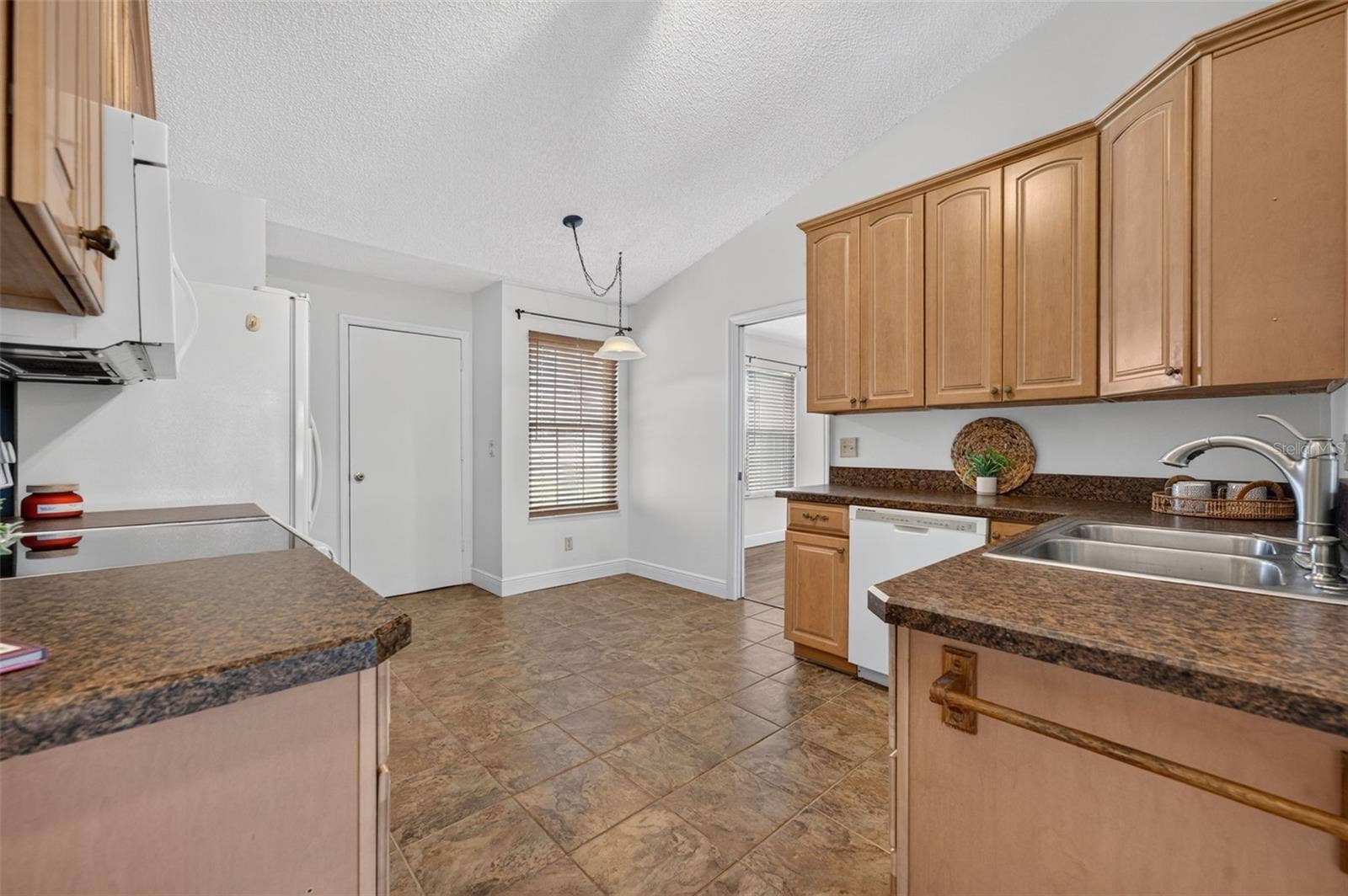 The open sapce in the kitchen is a charming spot for a cafe table.