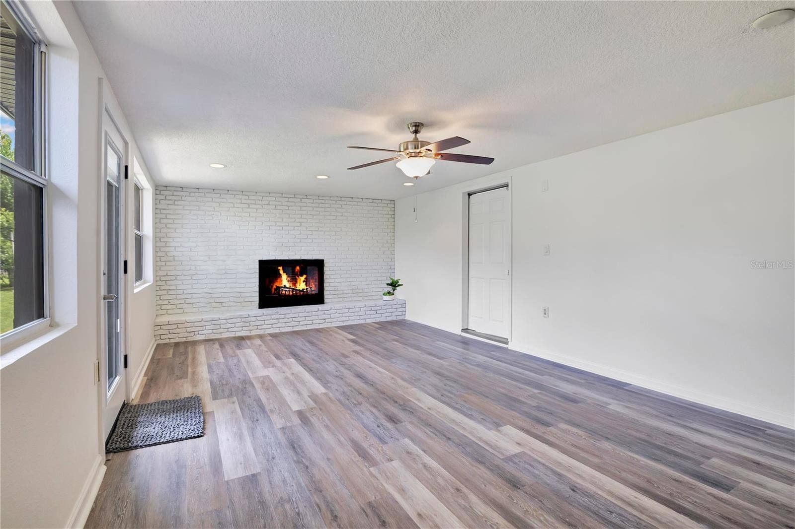 4415 HAYLOCK DRIVE, Orlando, FL 32807 Family room with wood-burning fireplace