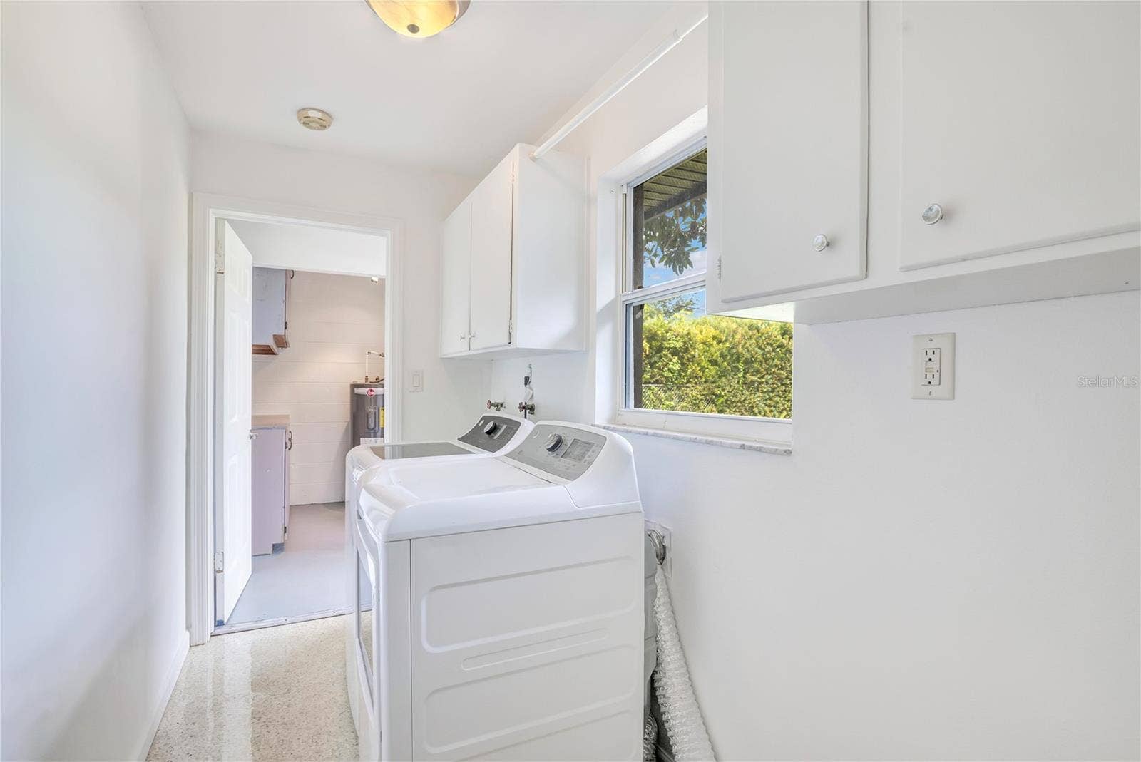 4415 HAYLOCK DRIVE, Orlando, FL 32807 Indoor laundry room leading to workshop in garage